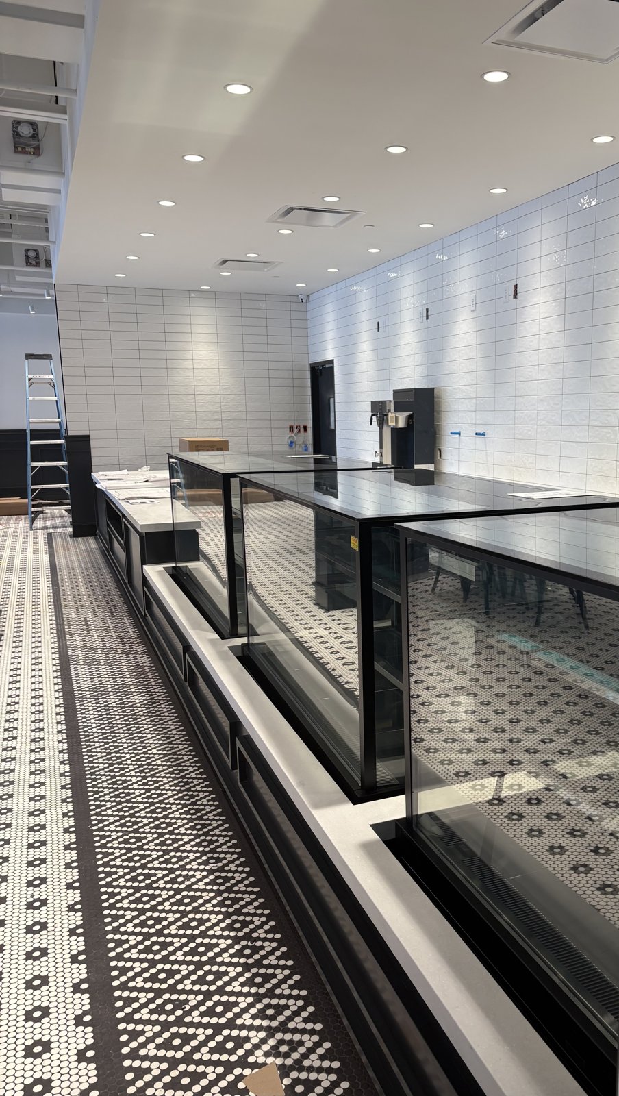 Paris Baguette display cases being installed during the café build-out
