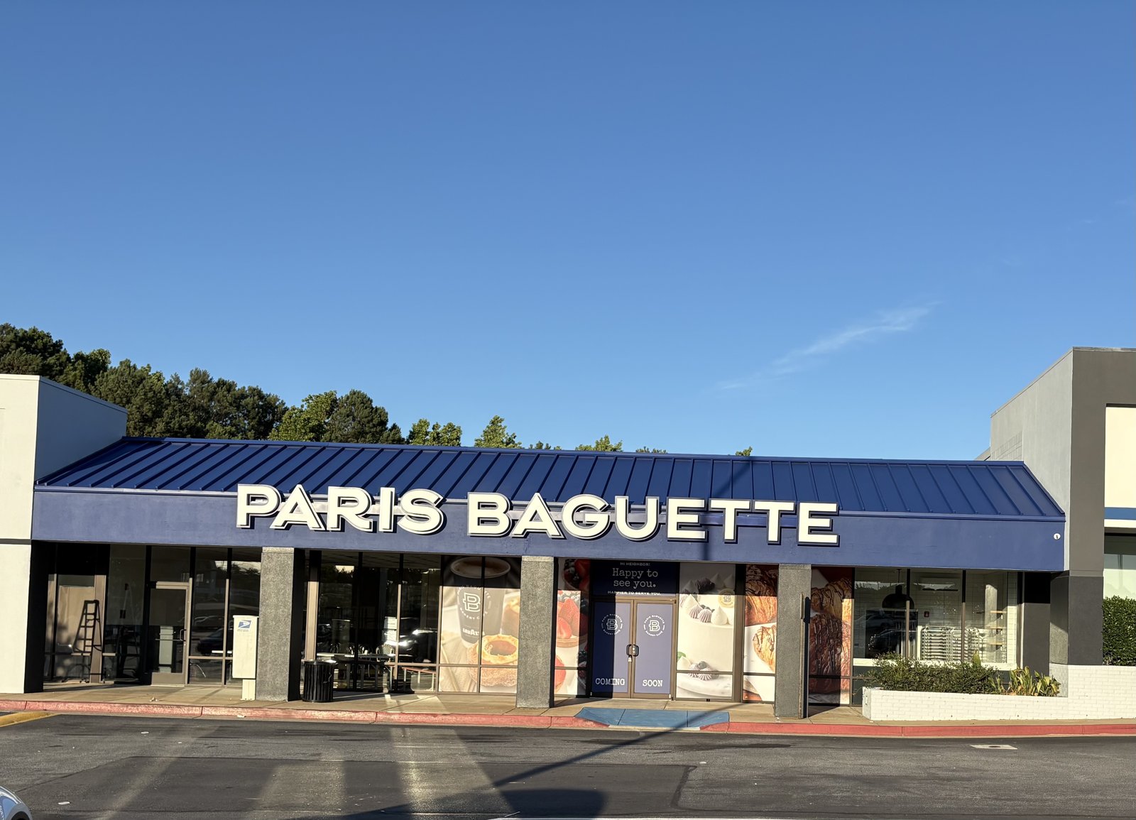 New Paris Baguette café storefront with signature blue metal canopy